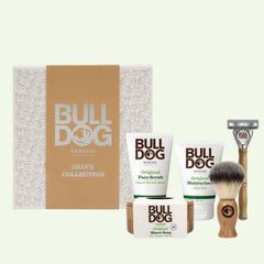 The Premium Gift: Shave Collection includes a face scrub, moisturizer, shave soap, bamboo razor, and shaving brush in front of a branded gift box—an ideal gift set for men.