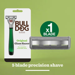 The Original Glass Razor in plastic-free packaging appears on a green background beside a close-up of its cartridge. Text reads: x1 Blade, 5-blade precision shave for a close, comfortable experience.