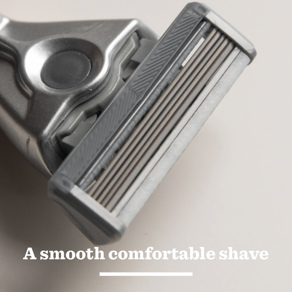 Close-up of the Original Glass Razor head on a light surface, with A close and comfortable shave in white letters below, highlighting our plastic-free packaging.