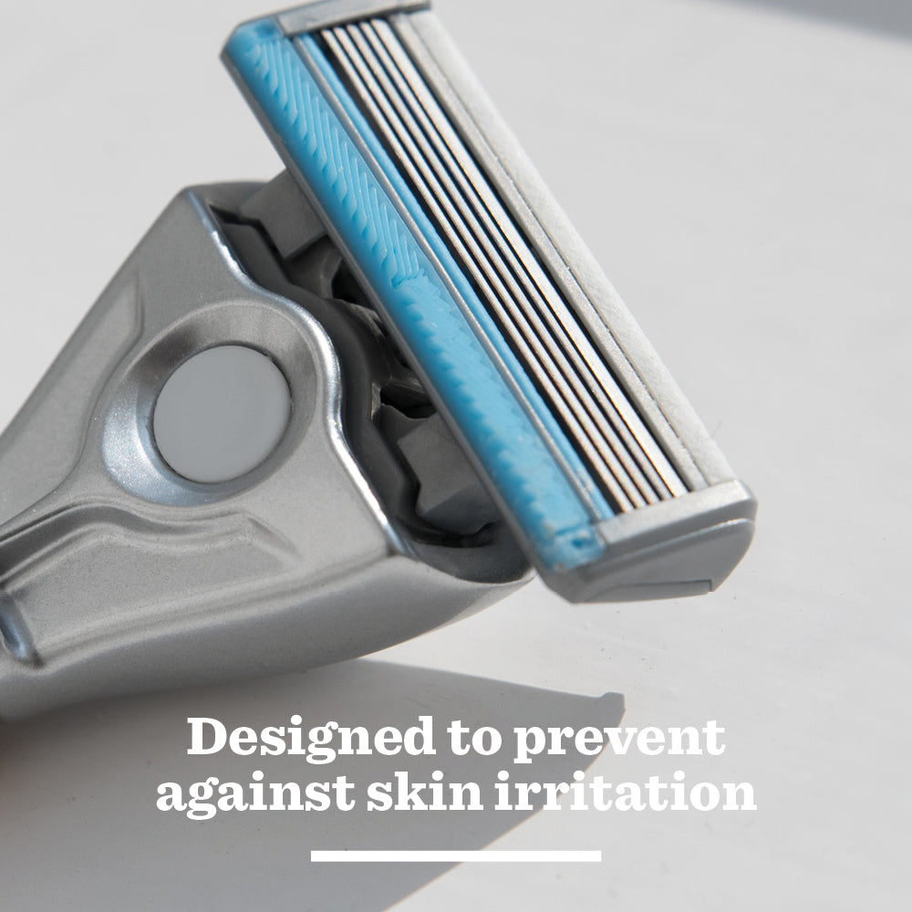 Close-up of the Sensitive Ceramic Razor featuring a blue strip above its blades on a white surface. Text below reads, Designed to prevent against skin irritation.