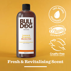 A bottle of Lemon & Bergamot Shower Gel is displayed against a yellow background, highlighting its 100% natural fragrance, vegan-approved and cruelty-free labels, plus a “Fresh & Revitalising Scent”—ideal for men’s skincare routines.