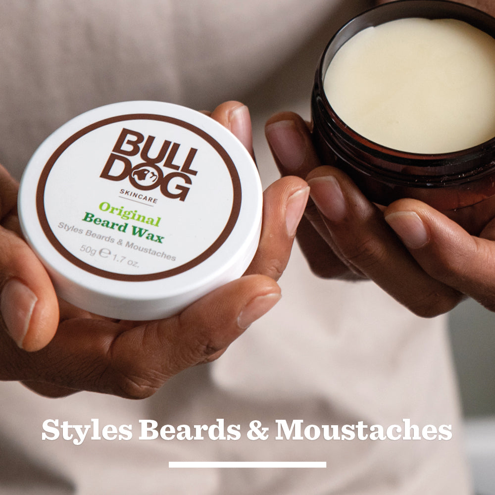 A person holds an open jar from the Beard Collection Bundle in one hand and the lid in the other. The text below reads, Styles Beards & Moustaches.