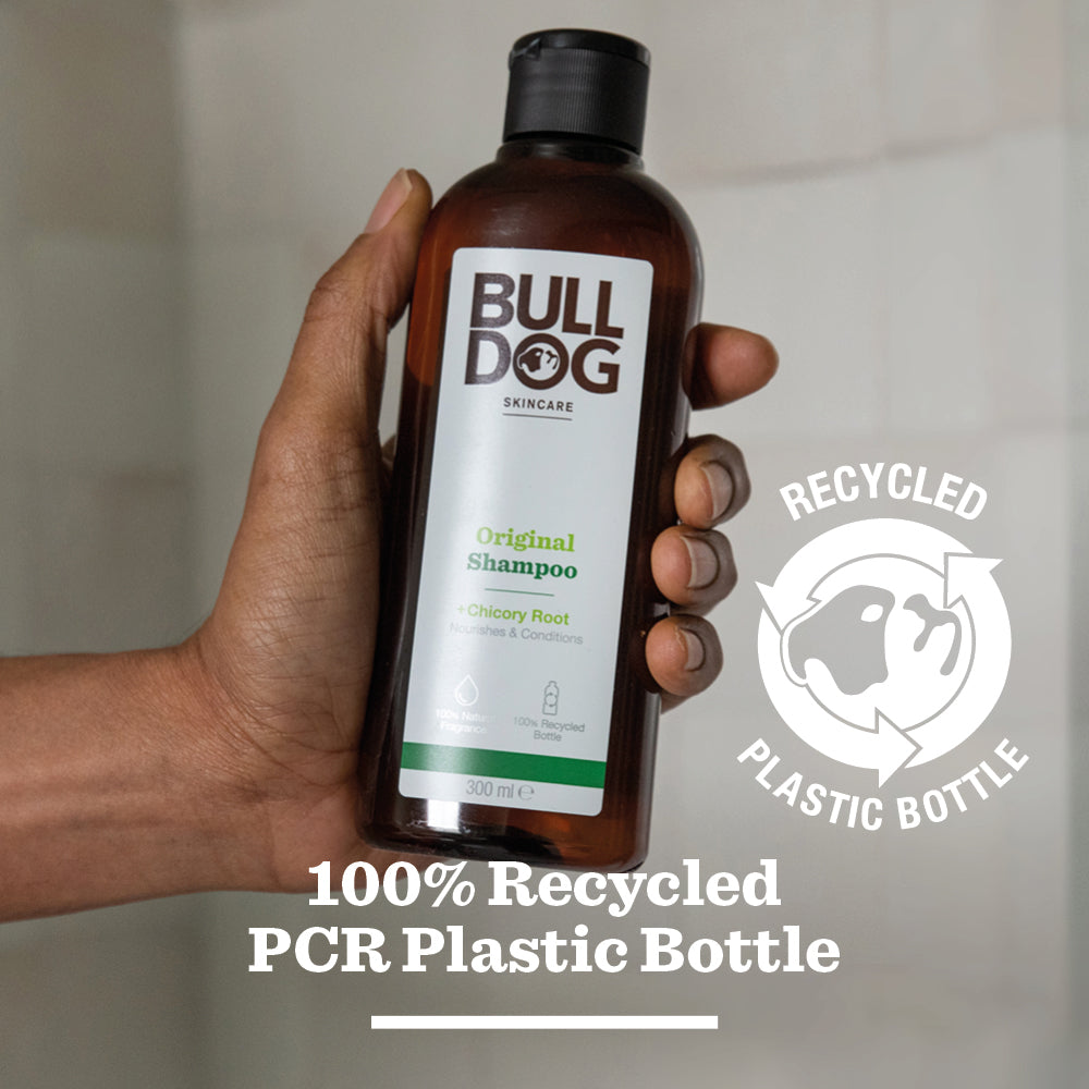 A hand holds a bottle of Original Shampoo with a green label, emphasizing natural ingredients. White text on the image reads 100% Recycled PCR Plastic Bottle and features a recycling symbol.