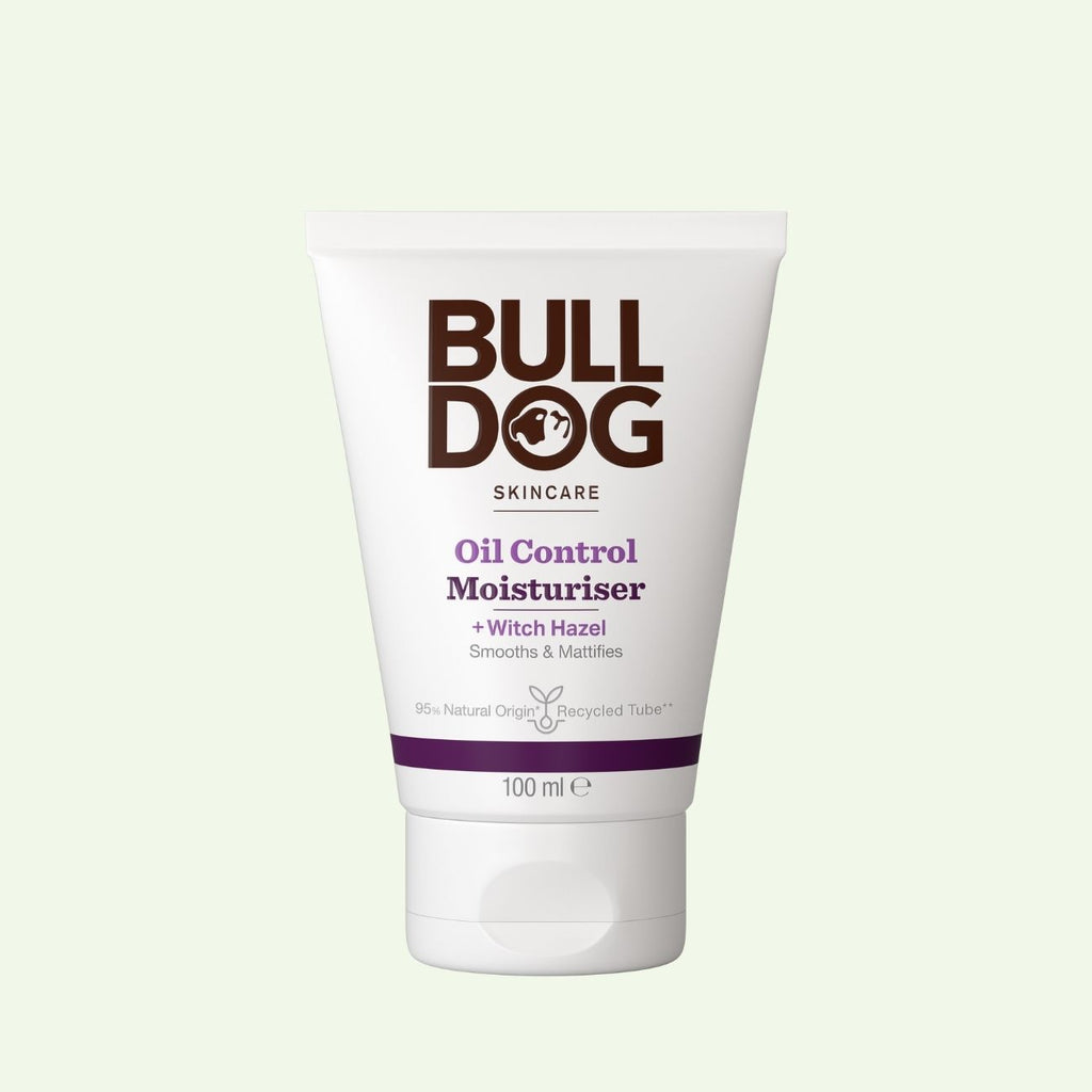 A 100 ml tube of Oil Control Moisturiser for men, formulated for oily skin with natural origin ingredients and witch hazel, in white packaging with dark brown and purple text.