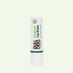 A white tube of Original Lip Balm stands upright against a plain light background. The label features the Bulldog logo and green text, emphasizing its original formula with long-lasting hydration.