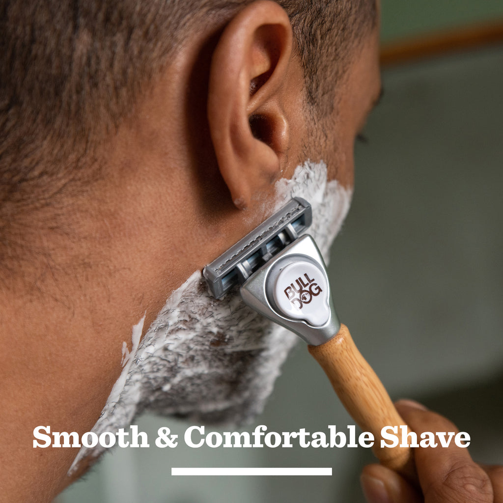 A close-up of a man shaving with the Premium Gift: Shave Collection bamboo razor, his face covered in shaving cream. The text "Smooth & Comfortable Shave" appears—ideal for fans of quality grooming or as a gift for men.