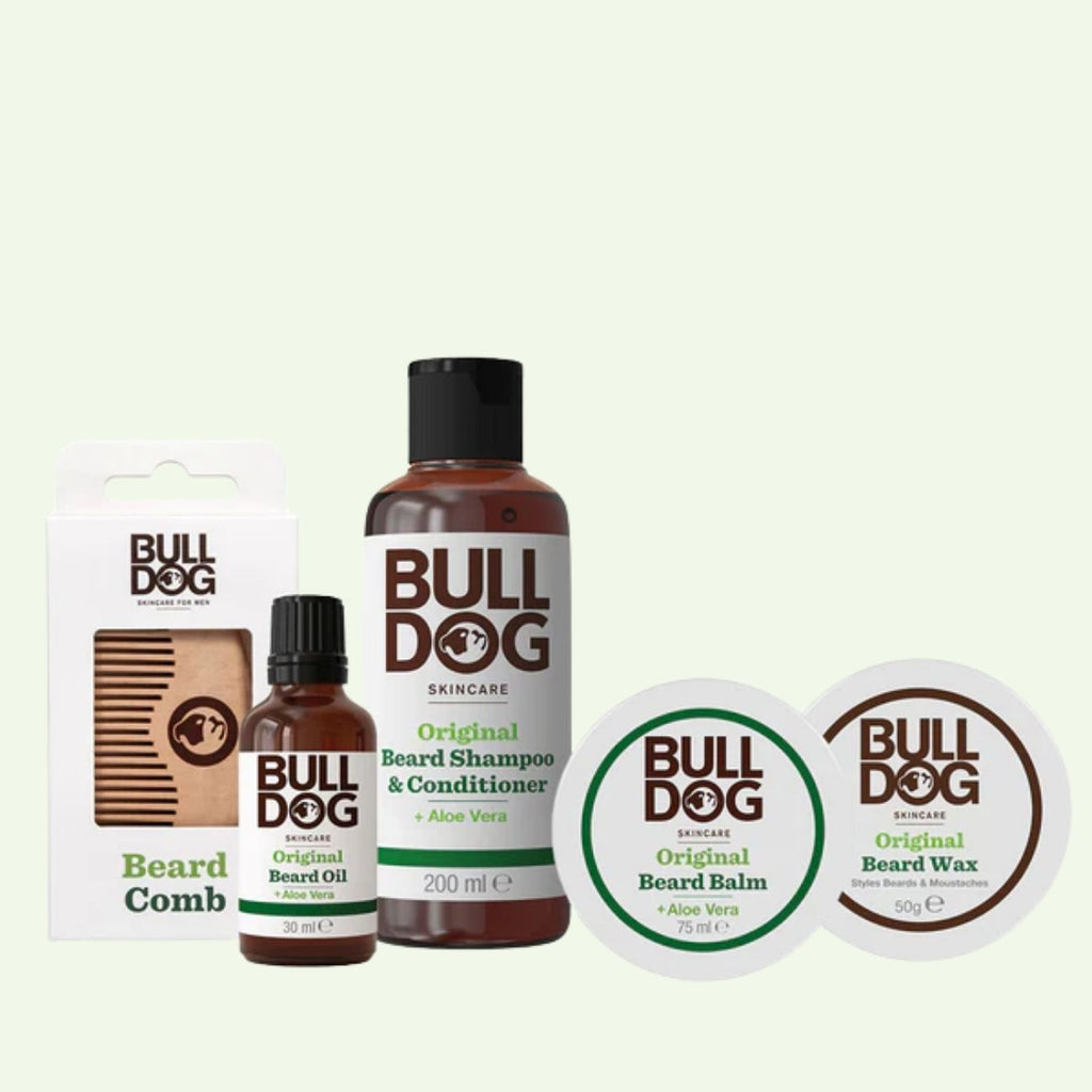 The Beard Collection Bundle features a beard comb, oil, shampoo & conditioner, balm, and wax—all in stylish brown and white packaging with signature green accents.