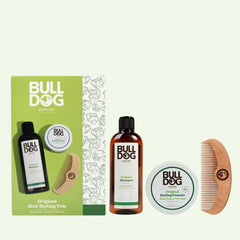 The Original Hair Styling Trio Giftset includes shampoo, styling pomade, and a wooden comb in green-and-white packaging. These top hair essentials for men are stylishly arranged on a light background—ideal as a thoughtful gift.
